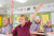 School students raising hands in class